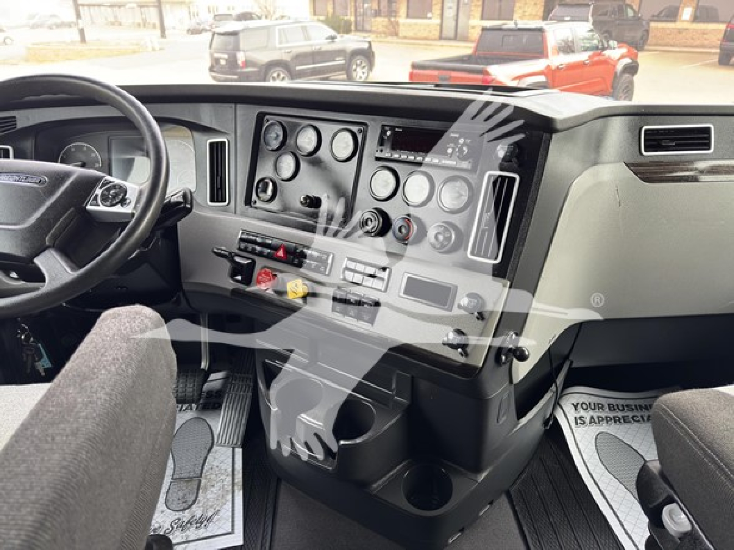 Freightliner Cascadia 126 dash and steering wheel view showing instrument gauges and control panel in cab.