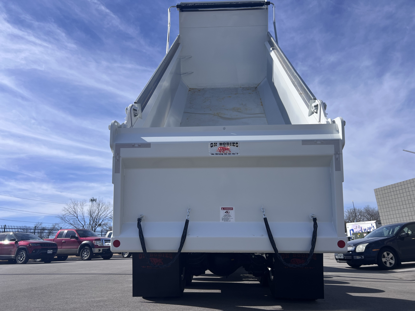 Dump truck bed of a 2026 Mack GR64F showing open dump bed and rear end with hydraulic components.