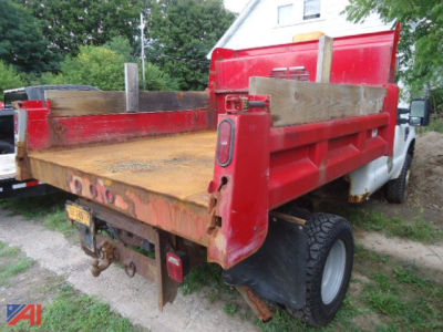Dump bed of a 2009 Ford F-350 Super Duty dump truck with plow showing rear and side panels