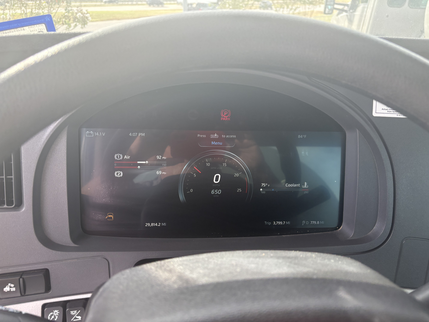 Kenworth T880 cockpit view showing digital instrument cluster with zero speed and various readouts.
