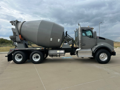 Kenworth T880 mixer truck side view showing large concrete mixer drum and cab with chrome steps and side mirror