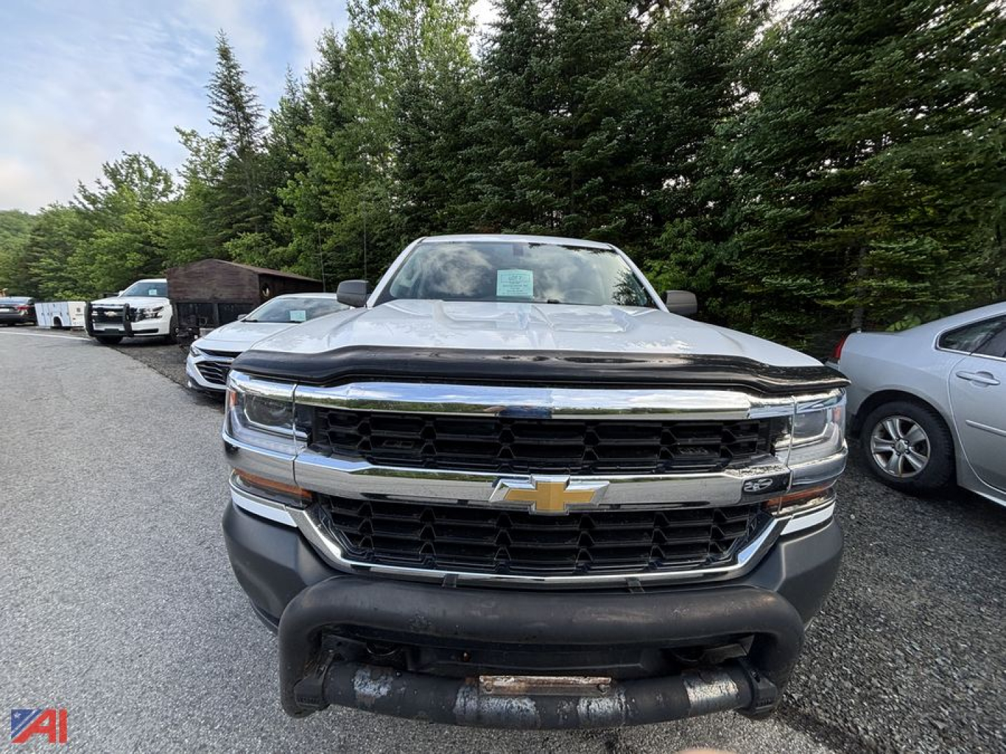Front view of a 2018 Chevrolet Silverado 1500 Crew Cab pickup showing chrome grille and bumper, headlights, and Chevrolet emblem.