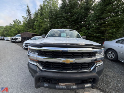 Front view of a 2018 Chevrolet Silverado 1500 Crew Cab pickup showing chrome grille and bumper, headlights, and Chevrolet emblem.