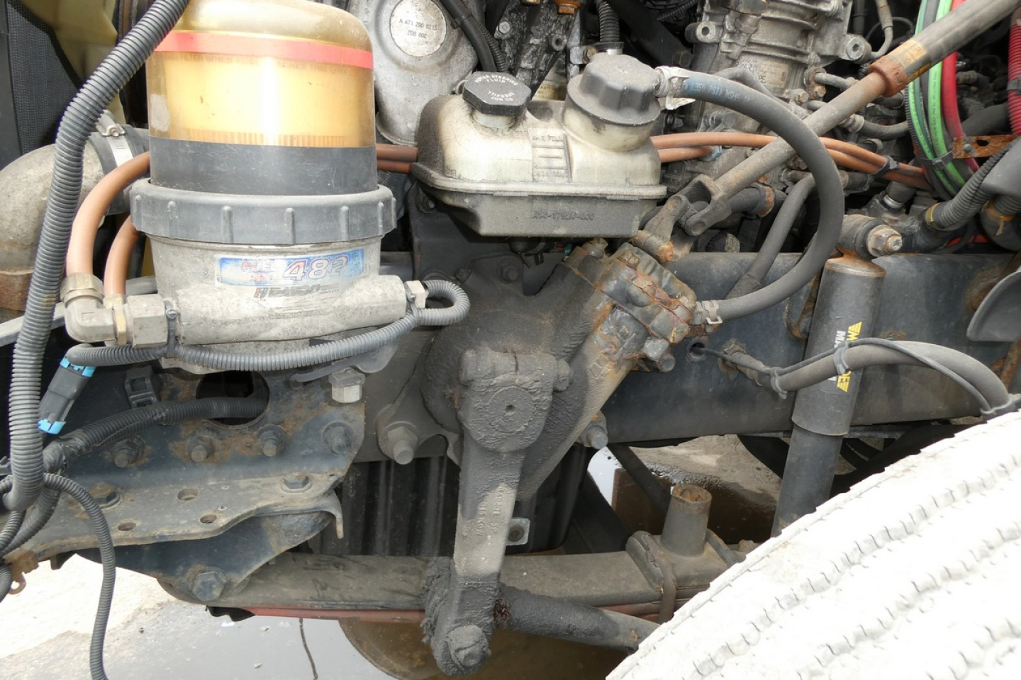 Freightliner Cascadia 125 engine bay showing diesel filter, hoses, and metal components with raw metal surfaces.