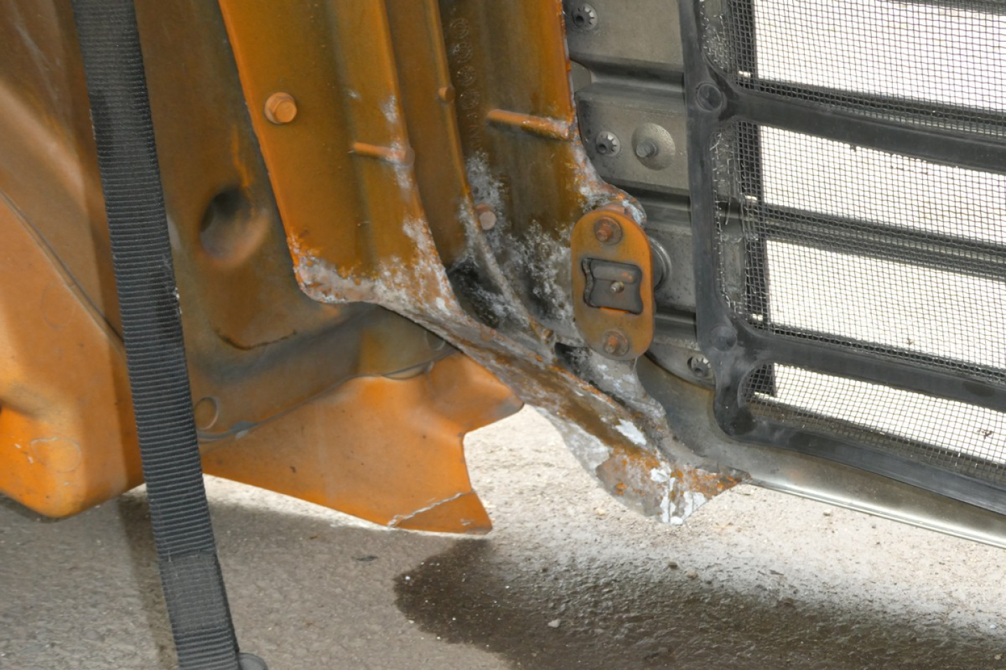 Front bumper area of a Freightliner Cascadia 125 daytime cab showing damaged lower bumper and frame near the grille.