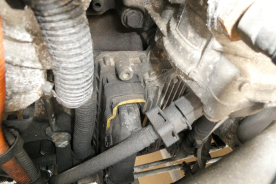 Engine bay view showing electrical harnesses and components in a Freightliner Cascadia 125 engine area.