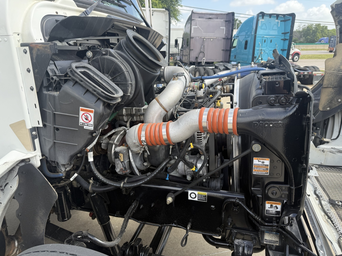 Kenworth T270 engine bay showing air intake, hoses, and radiator area.