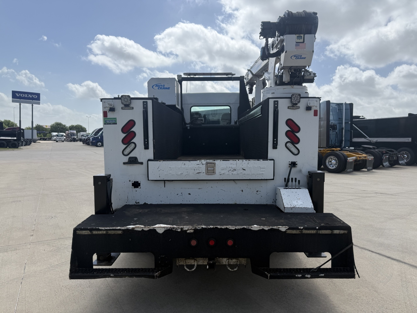 Kenworth T270 service truck rear view showing crane and platform, white with black bumper, tail lights and safety rails.