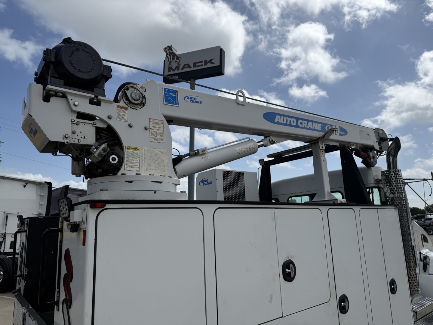 Kenworth T270 service truck with an Auto Crane boom and Mack crane label, side view showing utility body and crane arm details.