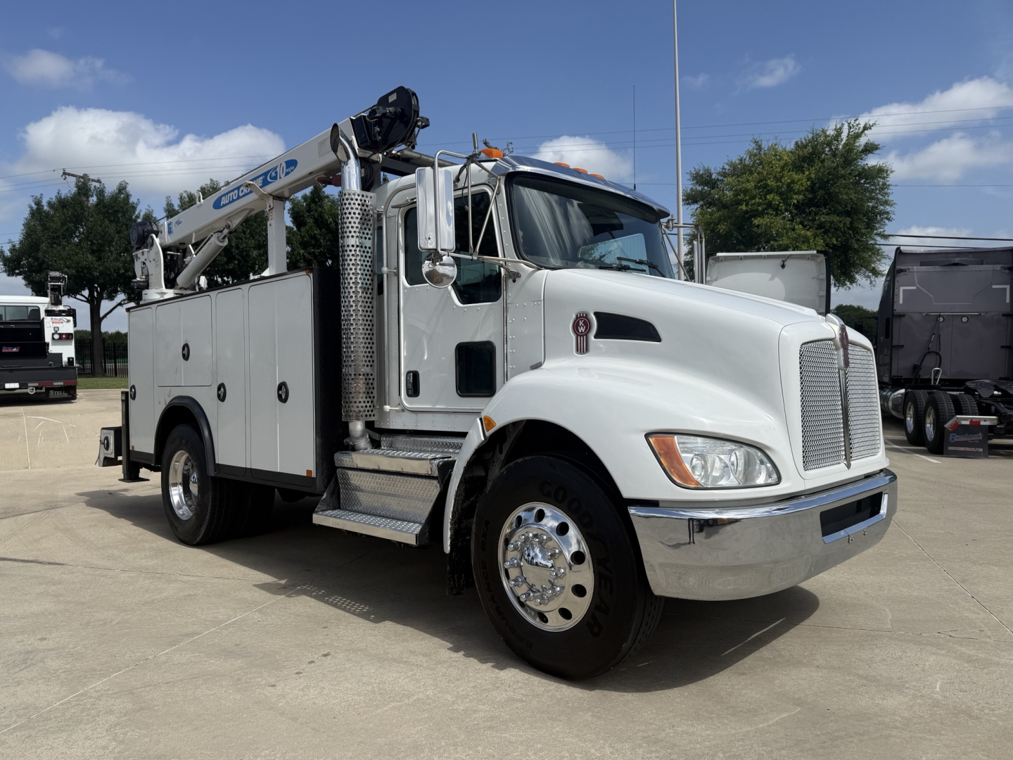 Kenworth T270 service utility truck with crane and tool compartments showing metal steps and dual rear wheels.