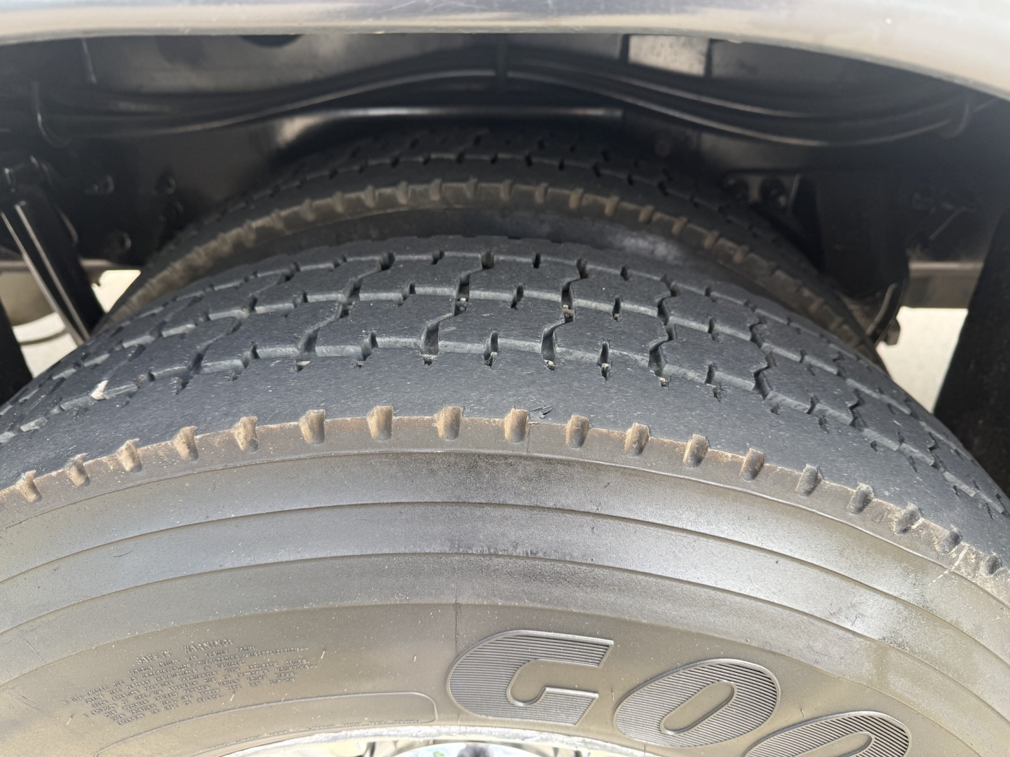 Kenworth T270 wheel and dual rear tires in-view showing tire tread and underbody components.