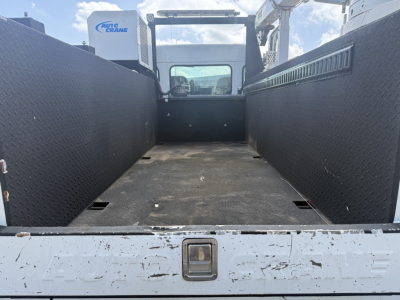 Kenworth T270 pickup area showing flatbed bed with diamond-plate side walls and rear access, cab in background, VIN 2NKHHM6X8LM420473.