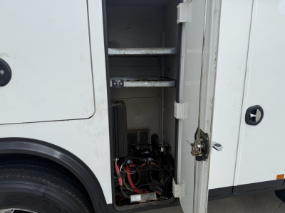 Kenworth T270 service truck side compartments with open rear storage showing electrical wires and equipment in the cabinet.