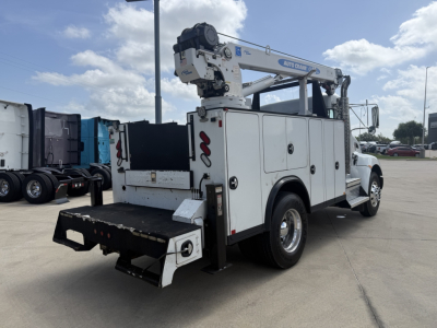 Kenworth T270 utility/service truck with crane rack and storage compartments, side-view showing rear hoist and tool storage, white paint, no visible damage.