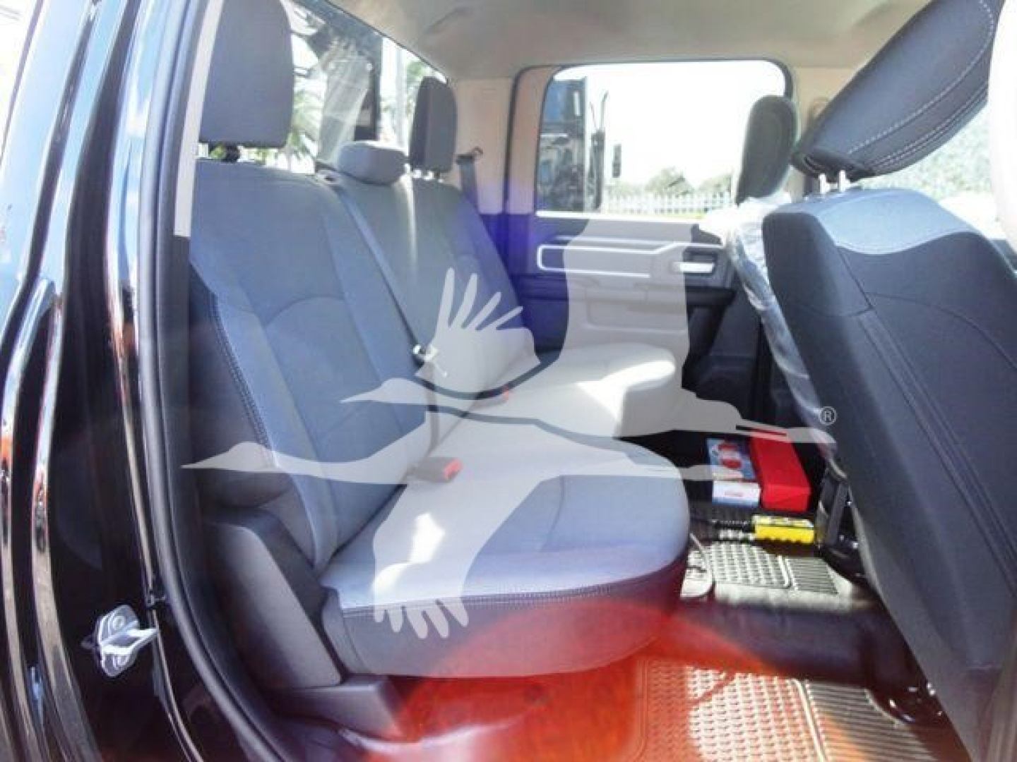 Ram 5500 SLT interior view showing front and rear seats with a partial center console and floor mats.