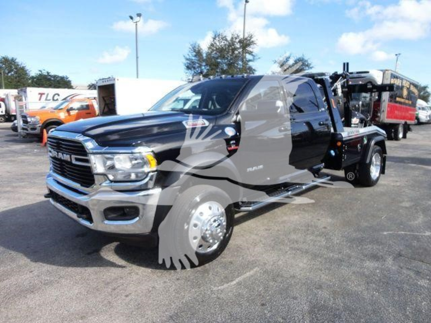 Ram 5500 SLT heavy-duty truck in a dealership lot, black and gray dual-tone cab with chrome front, long wheelbase, winch category