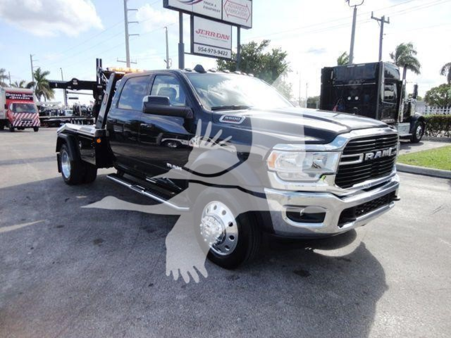 Ram 5500 truck in showroom lot with black cab and silver wheels, front grille RAM emblem, tow hitch, winch category vehicle, stock J68791.