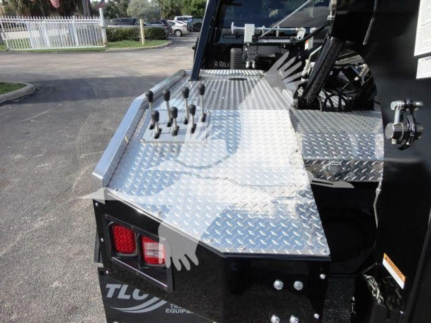 Ram 5500 SLT winch truck bed area with diamond plate toolbox and controls on aluminum surface.