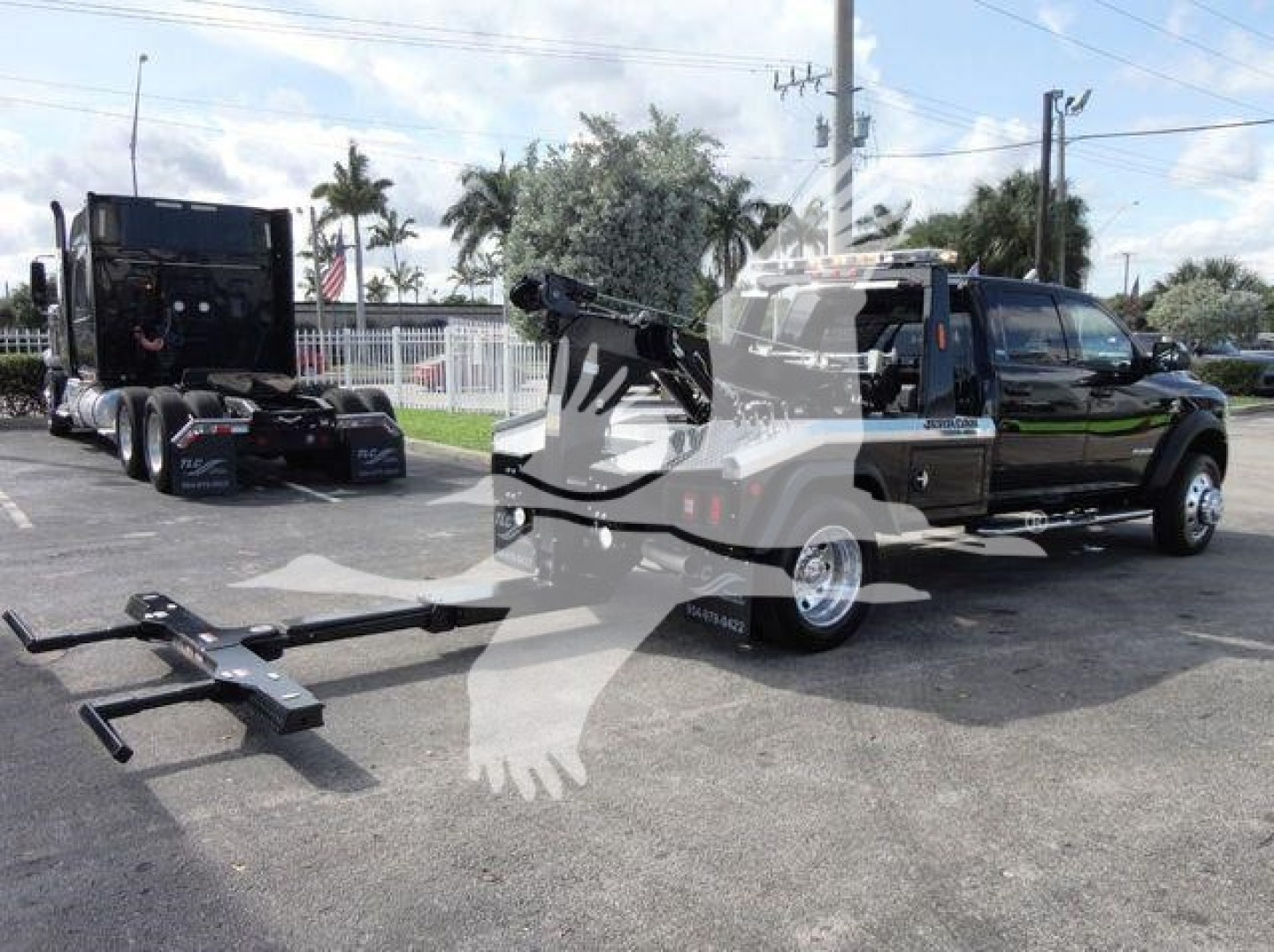 Ram 5500 SLT truck with winch setup showing front hitch and winch cable attachment in a dealership lot.