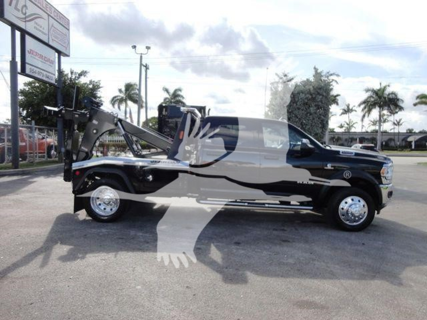 Ram 5500 SLT tow truck with a front winch, black body, extended tow rig, side view showing winch assembly and hoist, stock number J68791.