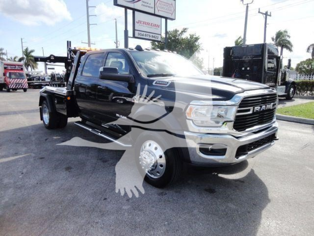 Ram 5500 truck in showroom lot with black cab and silver wheels, front grille RAM emblem, tow hitch, winch category vehicle, stock J68791.