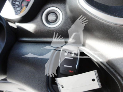 Ram 5500 SLT interior view near ignition with push start button and key fob inserted, dashboard with steering wheel edge visible.