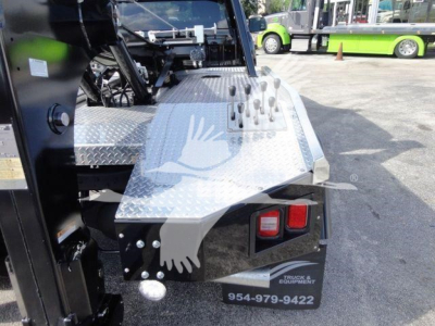 Ram 5500 SLT winch truck rear corner showing diamond plate step and toolbox with two taillights.