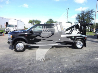 Ram 5500 truck with winch/tow equipment in side view, SLT trim, black exterior, custom graphics, stock number J68791.