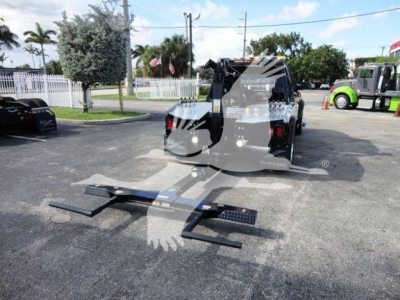 Ram 5500 SLT truck with winch platform and hitch components in foreground; rear view shows cargo bed and hydraulic lines