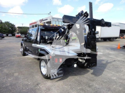 Ram 5500 tow/crew cab chassis with mounted winch and hoist, rear view showing black equipment and injection of winch assembly