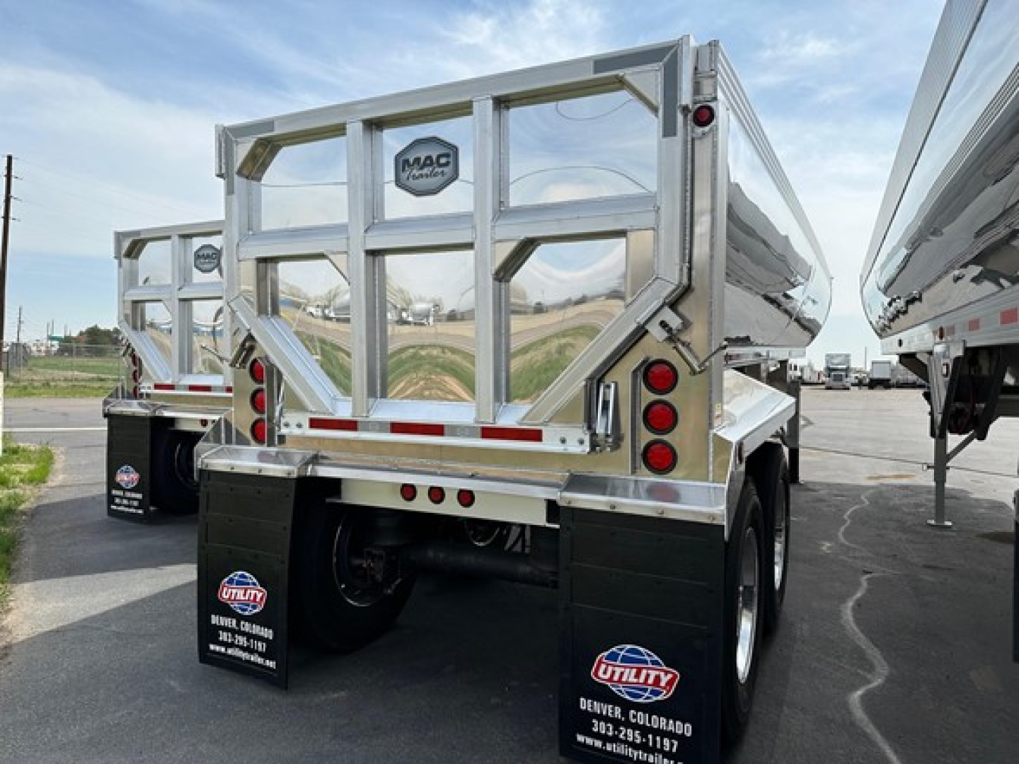 Macsimer Mac MacSimiser dump trailer rear view showing MAC brand logo and reflective aluminum panels.