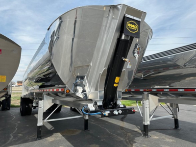 Dump trailer with Mac Macsimiser logo, polished aluminum tank, front hitch and support legs visible.