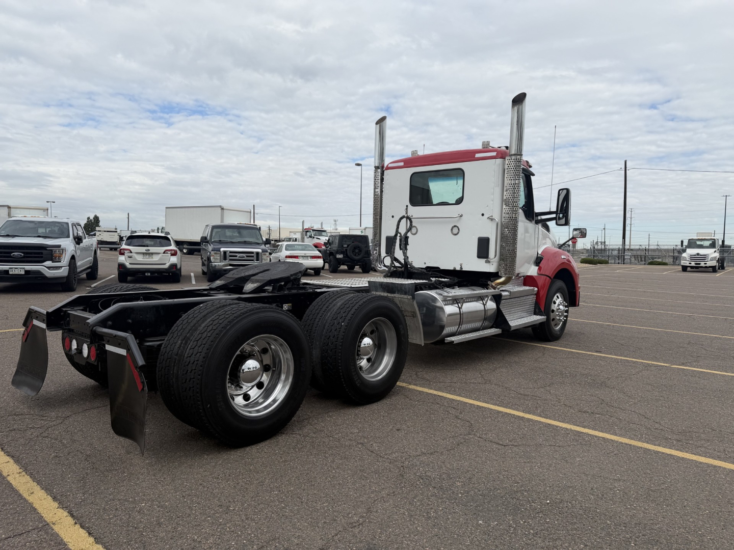 Kenworth T880 truck chassis with cab, rear view showing dual rear axles and fifth wheel mount. No specific text visible on components.