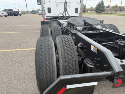 Kenworth T880 chassis rear view showing dual rear axles, tandem axle tires, and fifth wheel area.