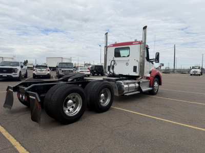 Kenworth T880 truck chassis with cab, rear view showing dual rear axles and fifth wheel mount. No specific text visible on components.