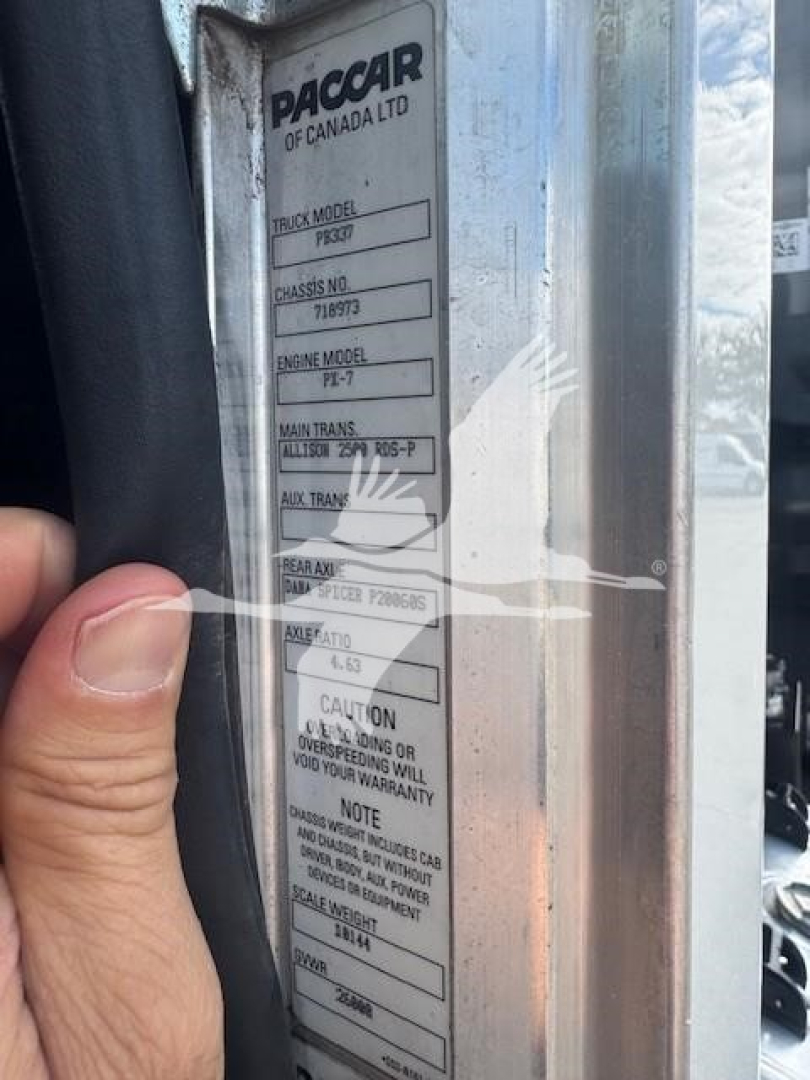 Paccar tag on Peterbilt chassis with labels: TRUCK MODEL P35? CHASSIS NO 718973 ENGINE MODEL PI-7 MAIN TRANS ALLISON ... AUX. TRANS ... CAUTION ...