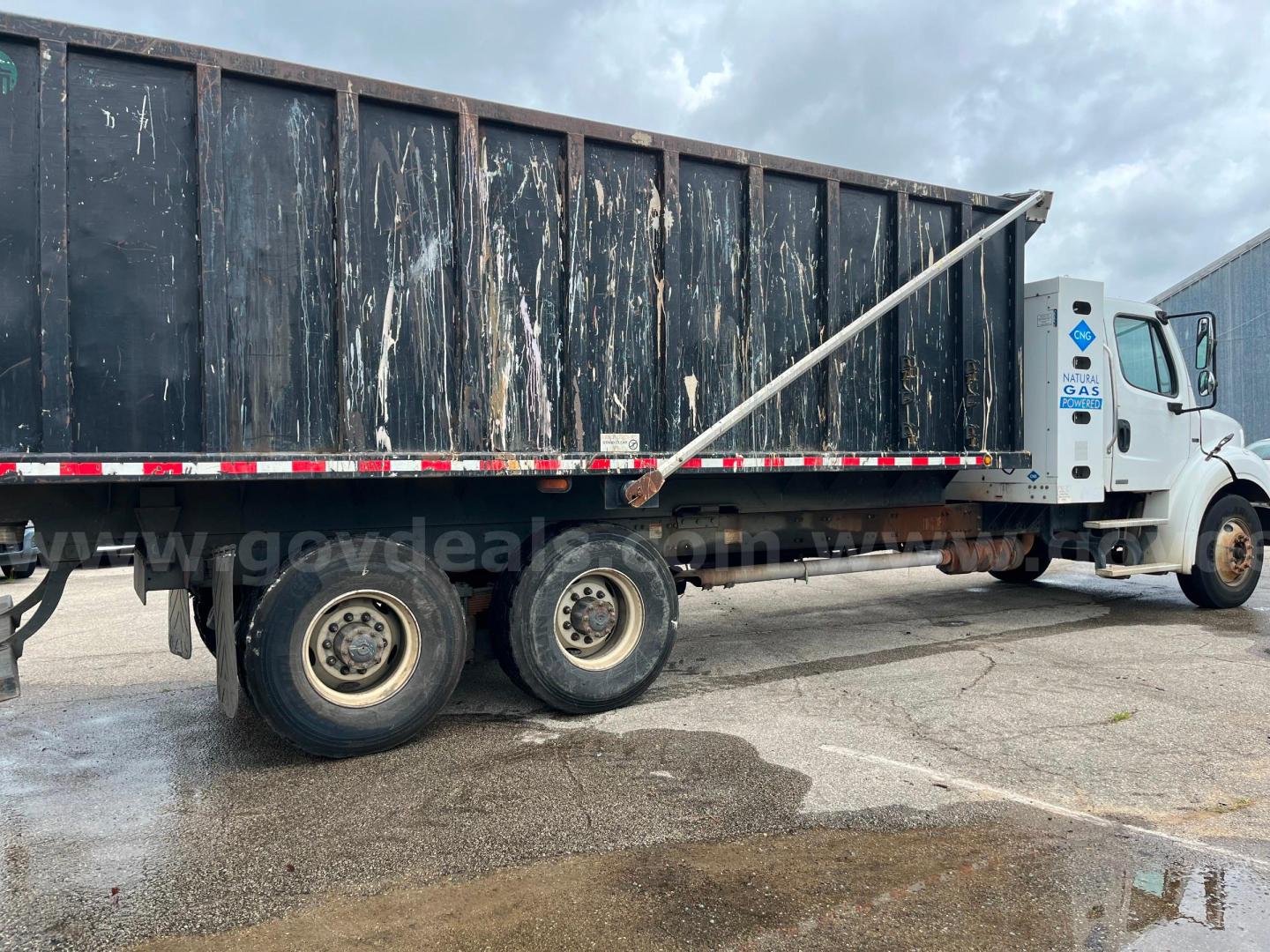 Truck side view showing 2013 Freightliner M2 112 dump body with dual rear axles and black dump bed, VIN 1FVHC5DXXDHFH4467, stock 12-7447, GCWR not visible.