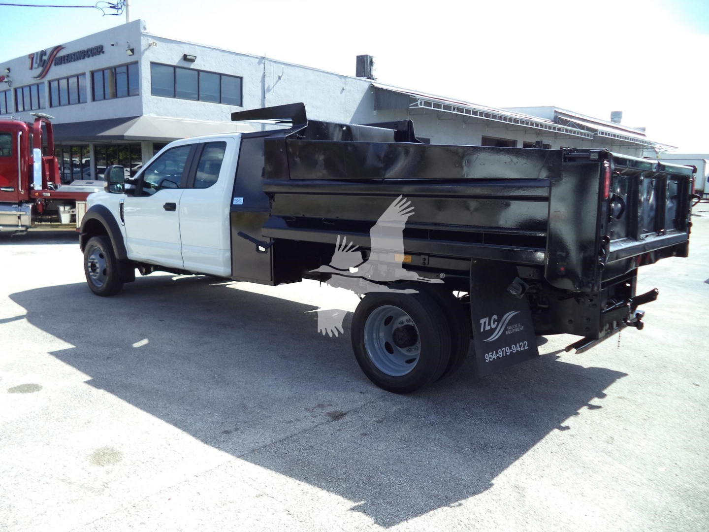 Dump truck rear side view showing dump bed and white cab on a used 2017 Ford F450 XL with stock number T27775.
