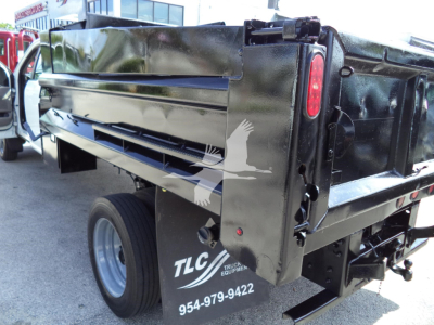 Dump truck bed of a 2017 Ford F450 XL with TLC equipment branding and stock/contact numbers visible on the side panel.