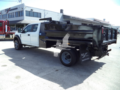 Dump truck rear side view showing dump bed and white cab on a used 2017 Ford F450 XL with stock number T27775.