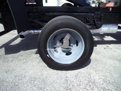 Ford F-450 chassis showing rear wheel and undercarriage with black frame and silver wheel rim.
