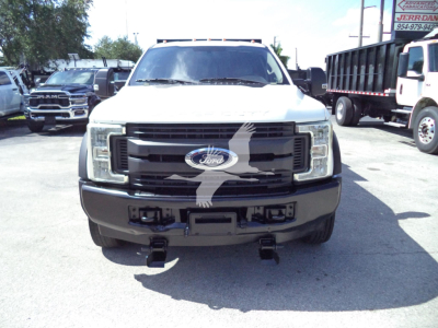 Ford F-450 front view showing grille, headlights, bumper and Ford emblem.