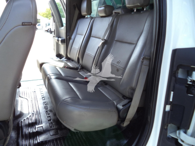 Ford F-450 interior rear seats with three-seat bench and seat belts; floor mat with 'Ford' branding visible.