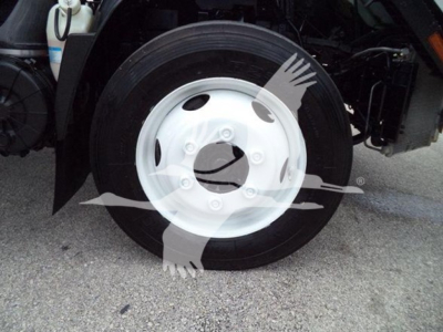 Isuzu NPR HD truck wheel and front fender showing white steel wheel and black tire.