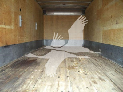 Truck cargo area showing wooden floor and walls, no visible text.