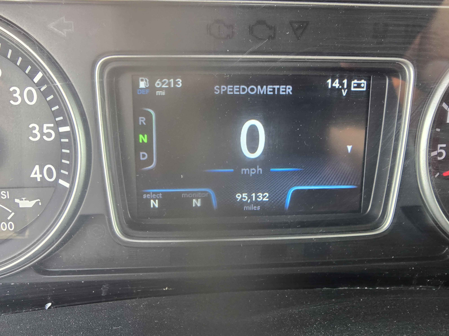 Dashboard showing digital speedometer reading 0 mph, gear indicators R N D, mileage 6213 mi, 95,132 miles on odometer, speedometer label, and small indicators around.