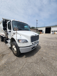 2021 Freightliner M2 106 truck front-left view showing cab and garbage body with stock number 26008-20.
