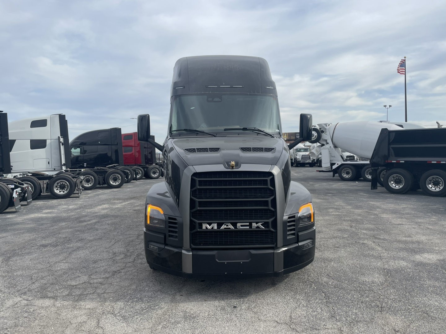 Front view of a new 2026 Mack PR64T76H truck showing bold grille, Mack emblem, headlights, and large windshield.