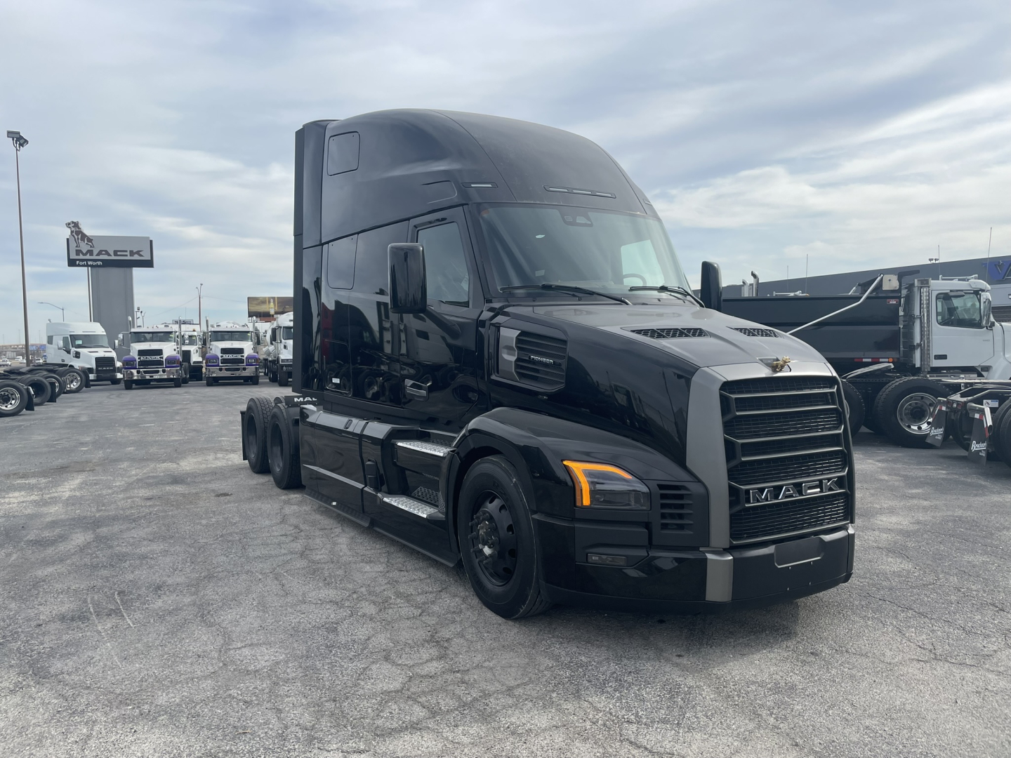 Mack PR64T76H semi-truck tractor in black, front three-quarter view, showing aerodynamic cab and grille.
