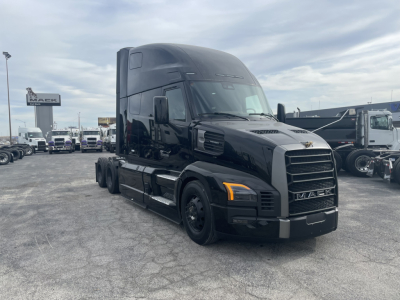 Mack PR64T76H semi-truck tractor in black, front three-quarter view, showing aerodynamic cab and grille.
